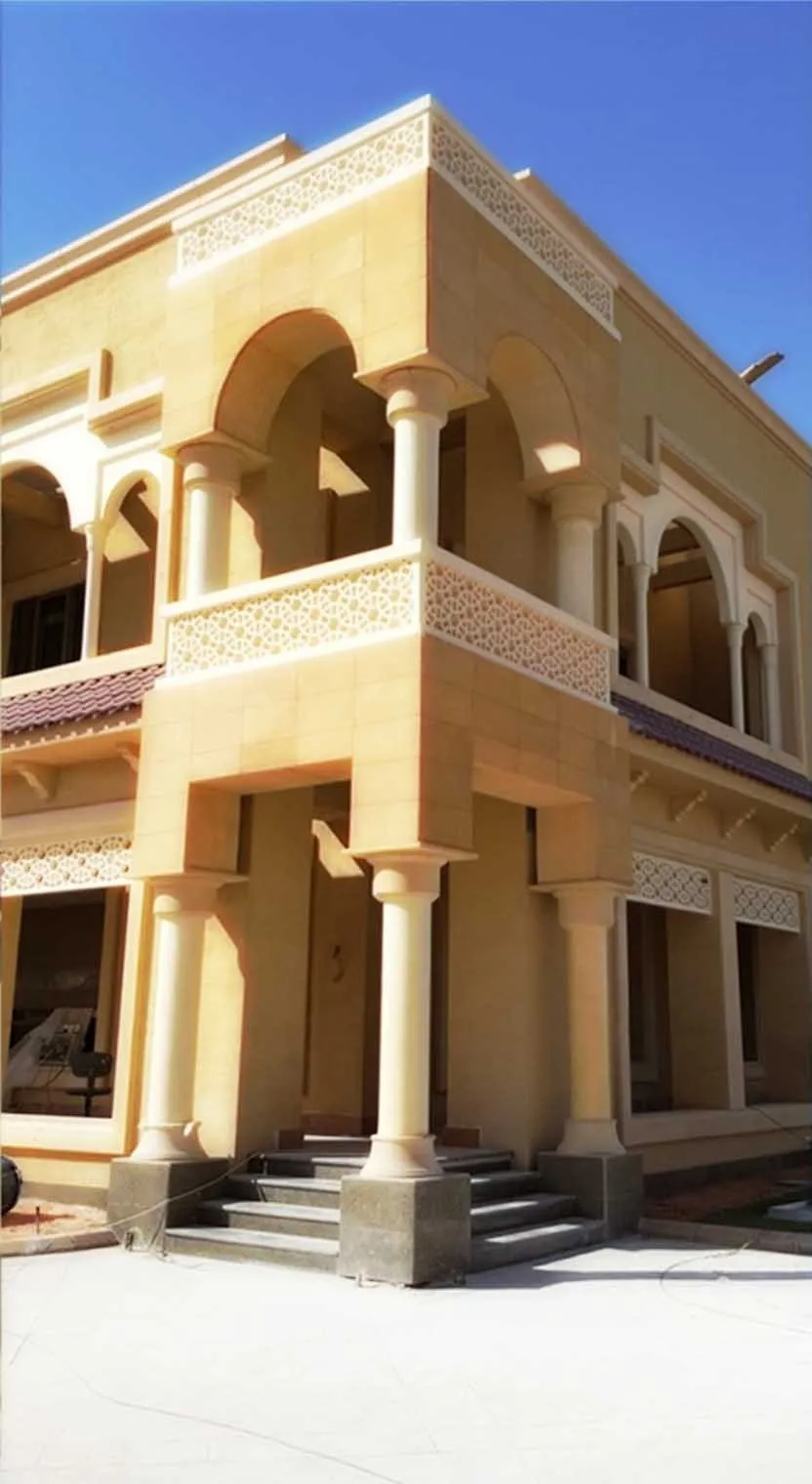 Stone palace elevation under construction in Riyadh, scaffolding removed and paving unfinished